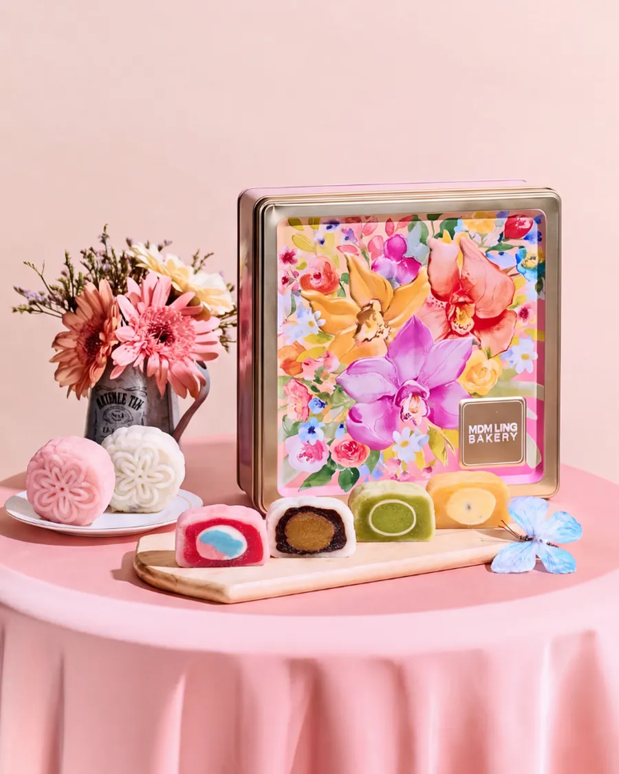 Orchid Reverie keepsake tin with snowskin mooncakes cut open to show their truffle centres